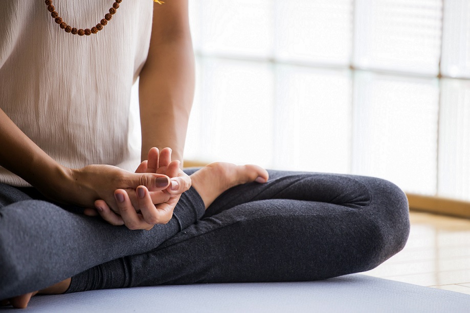woman meditating to reduce stress