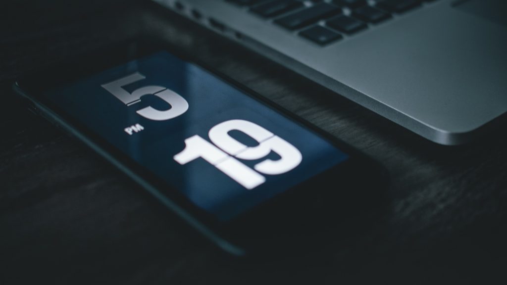 Eine digitale Uhr die die minutengenaue Zeiterfassung symbolisiert